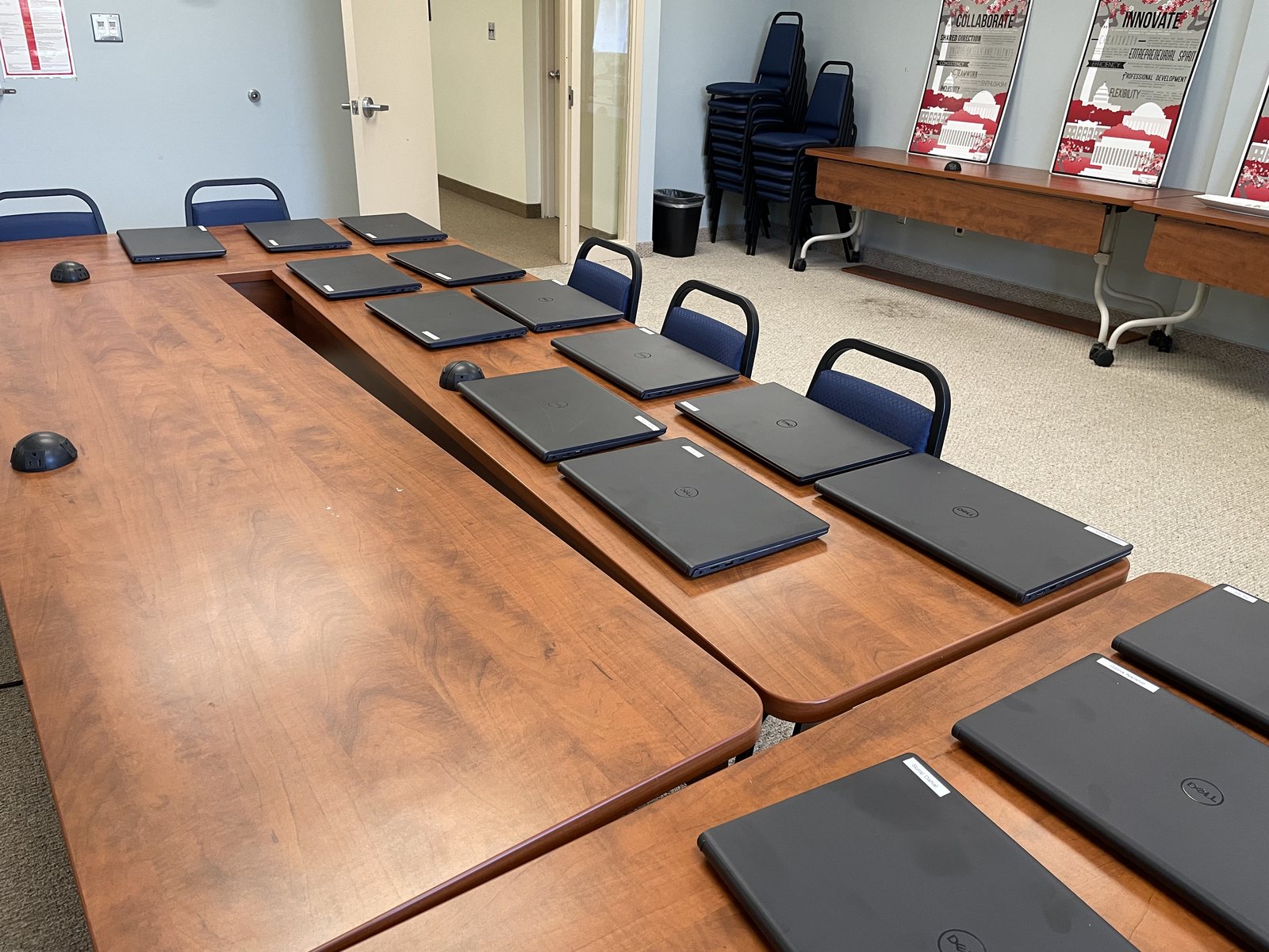 New laptops lined up on tables, ready to go out