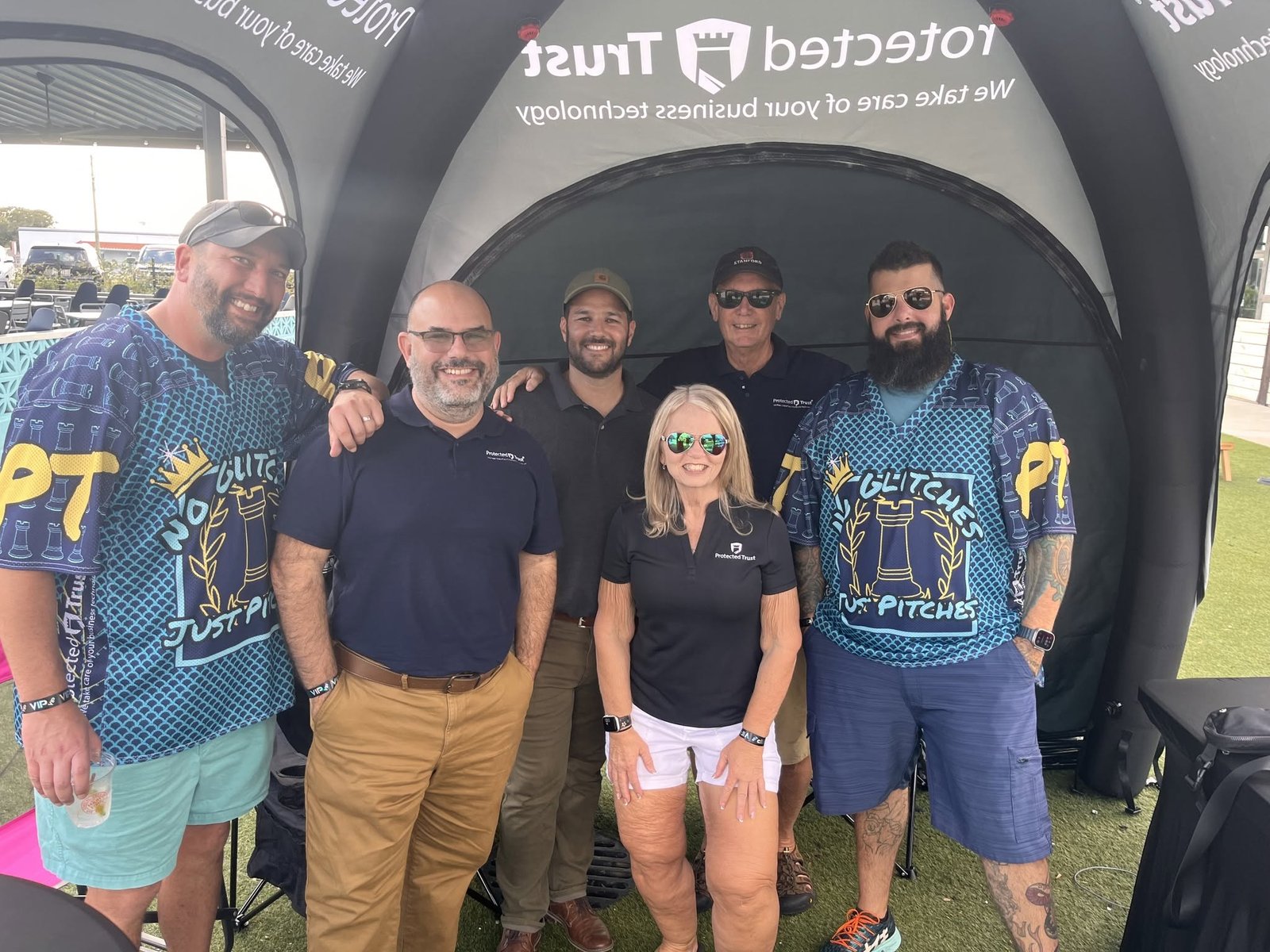 Our team in matching jerseys at the Protected Trust tent at the Endeavor Cornhole Classic