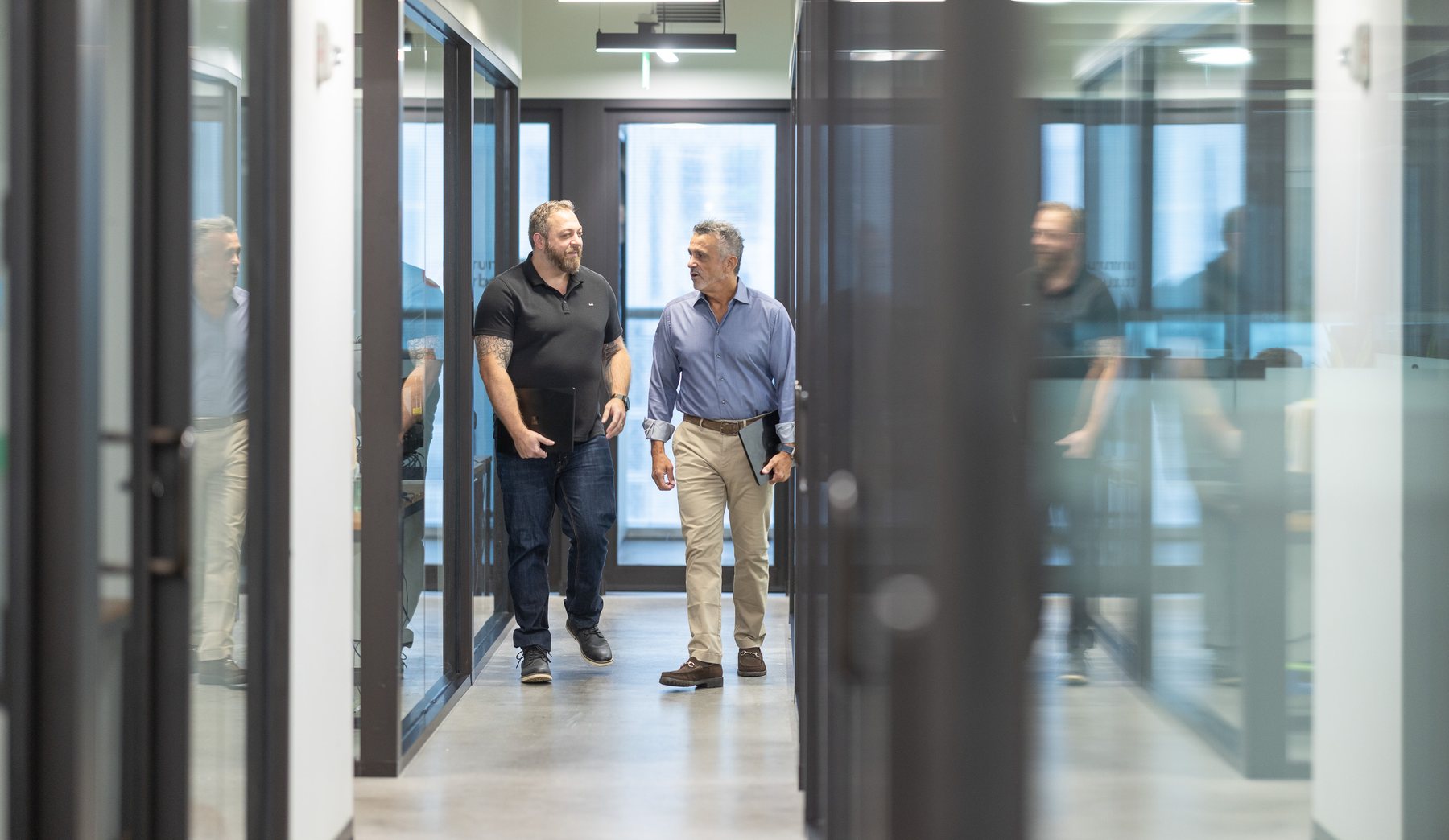 Three of the team walking the corridor