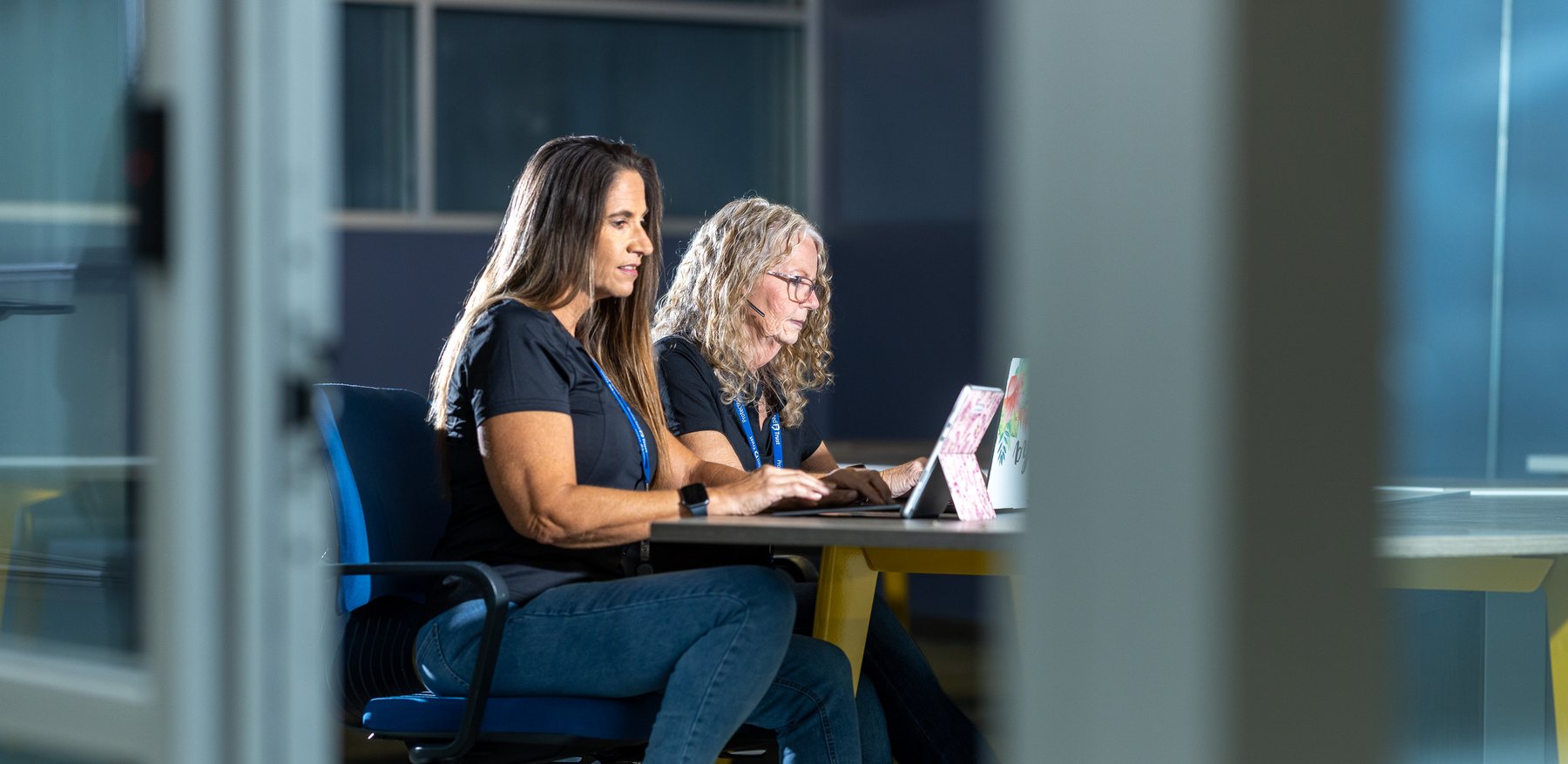 Two of the team at a laptop in Winter Haven